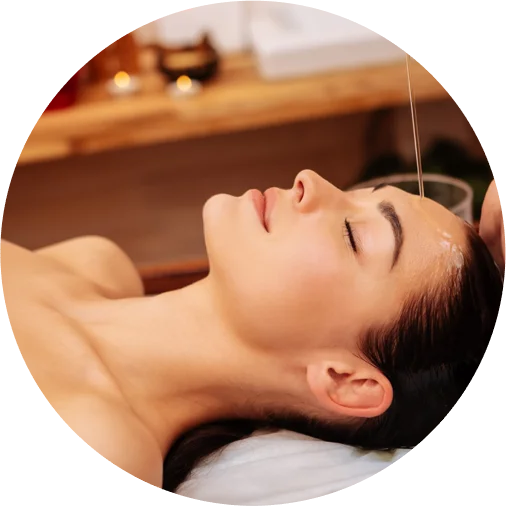 Woman receiving Shirodhara Ayurvedic oil therapy at Brahmi wellness center in Dubai